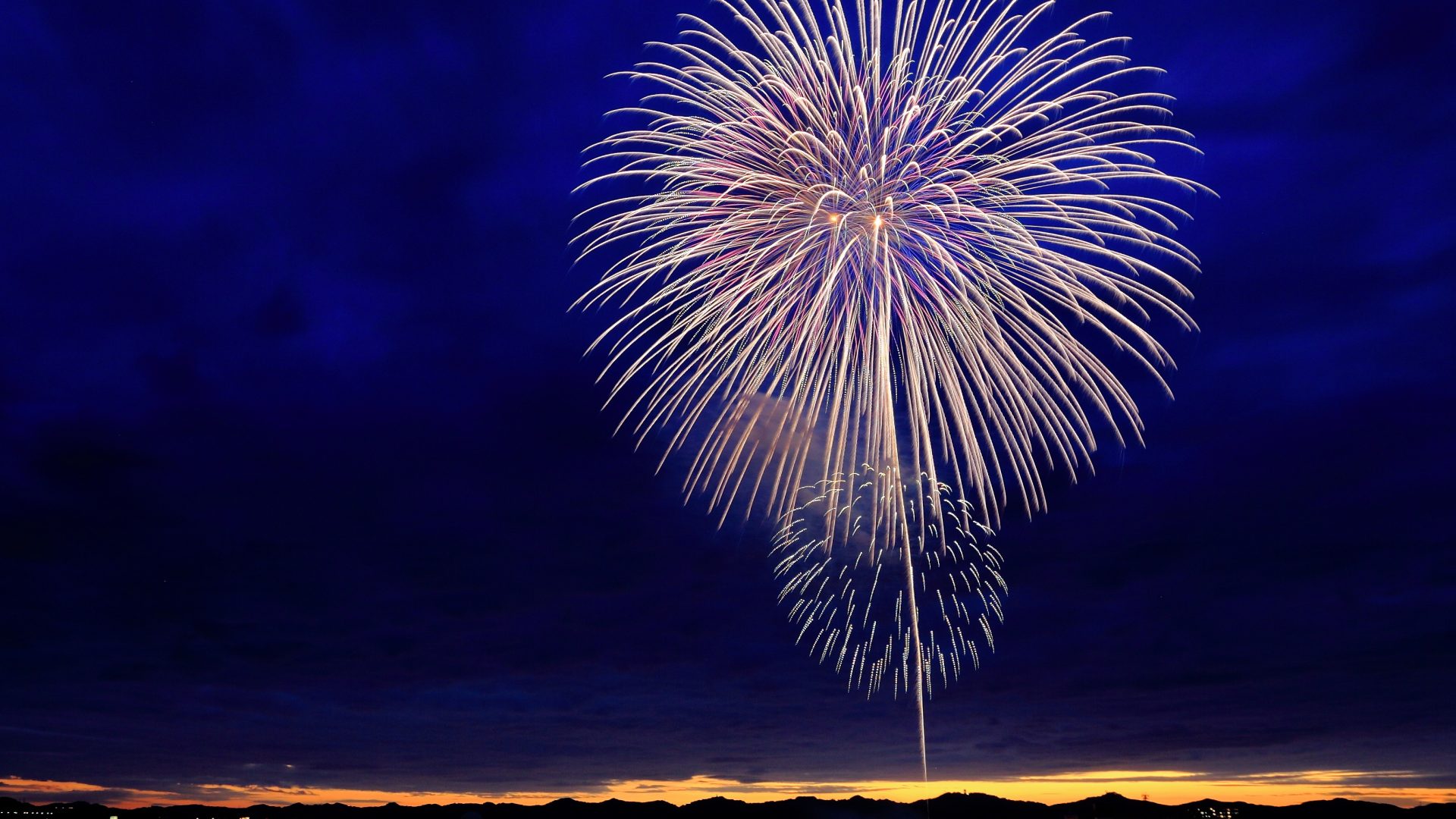 Fireworks burst against dark clouds — Vantage Robotics IPO Celebration