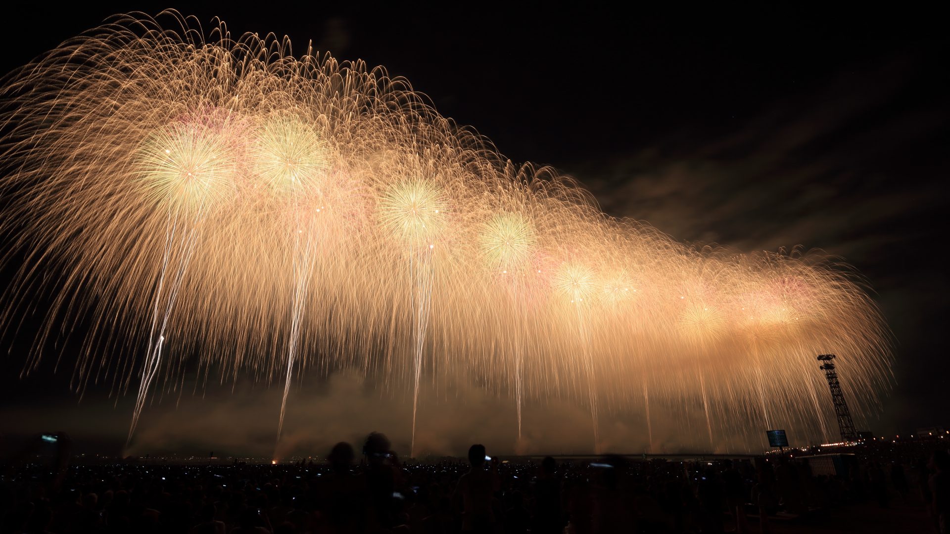 Arcing barrage of golden fireworks shells — Northgate Amphitheater Summer Finale