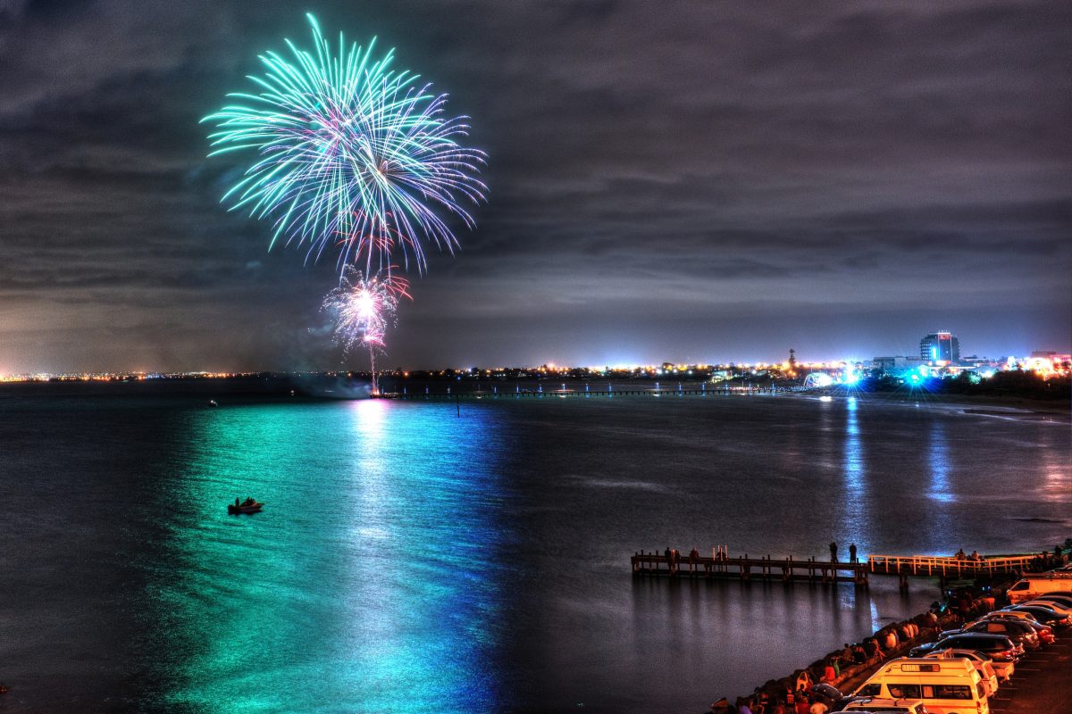 Fireworks over a harbor waterfront skyline — Port Alden Harbor Festival