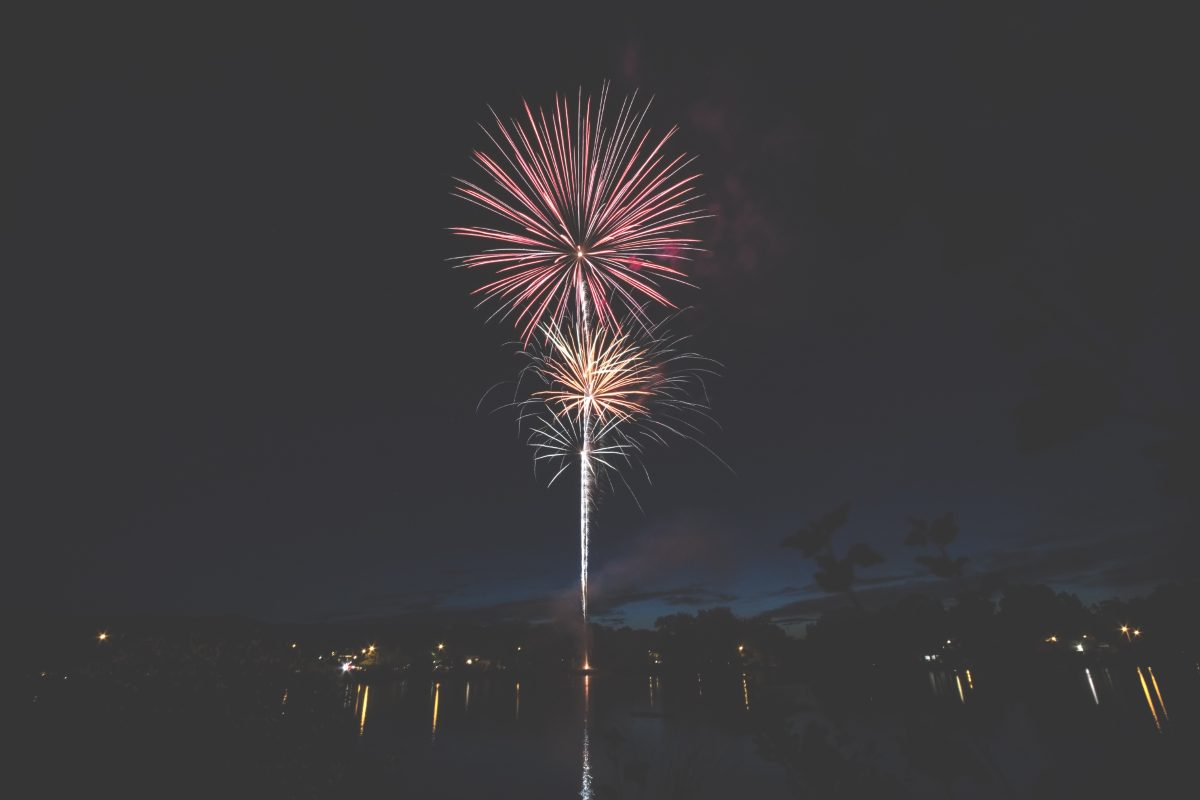 Fireworks display over water at night — Harborlight Tech Summit